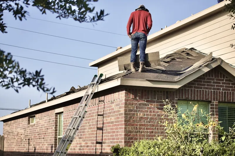 Professional roofer working on a residential roof in Long Green Woods